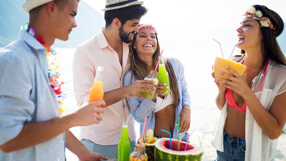 Friends celebrating a milestone with tropical drinks
